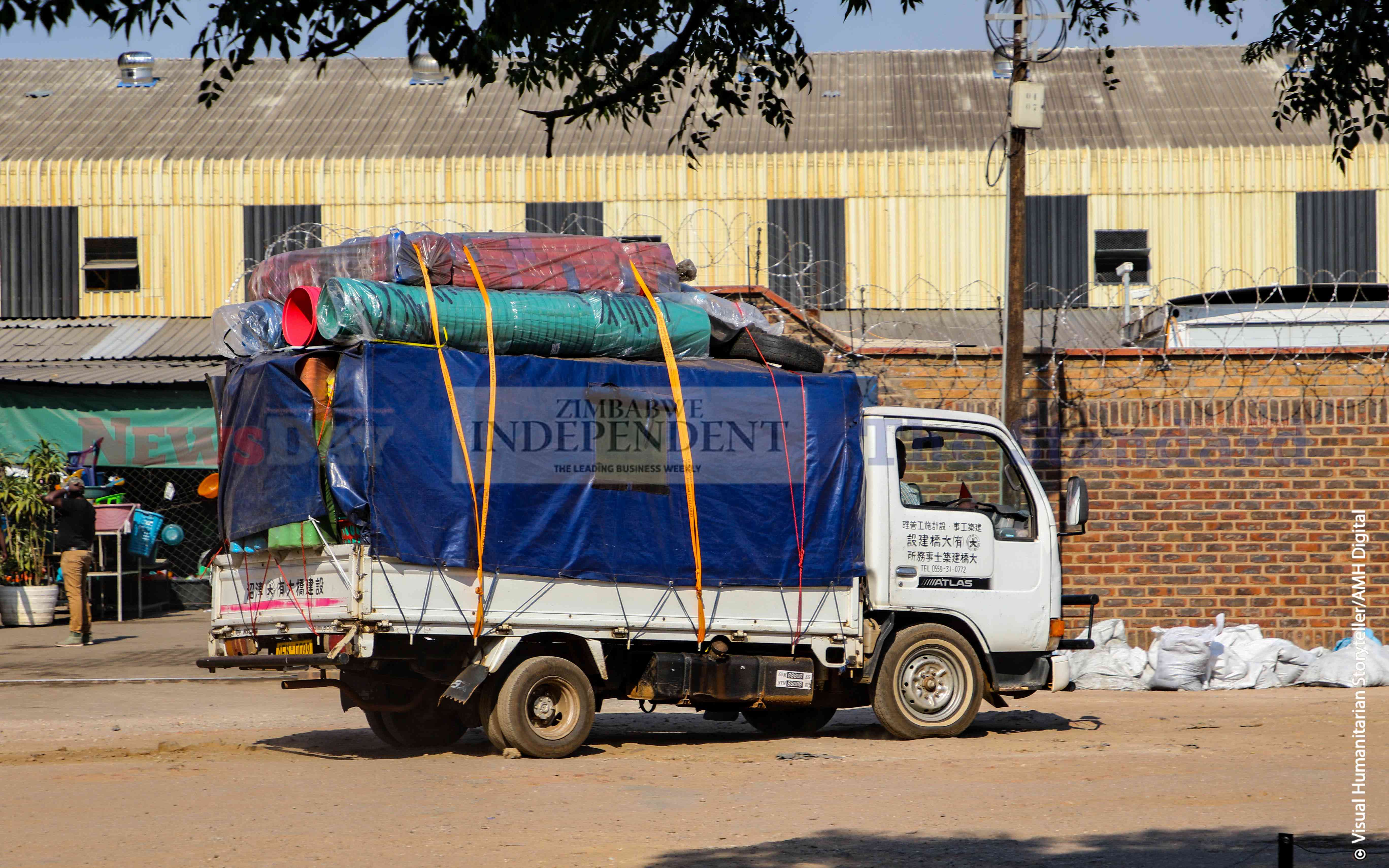 A motor vehicle carrying plastic buckets