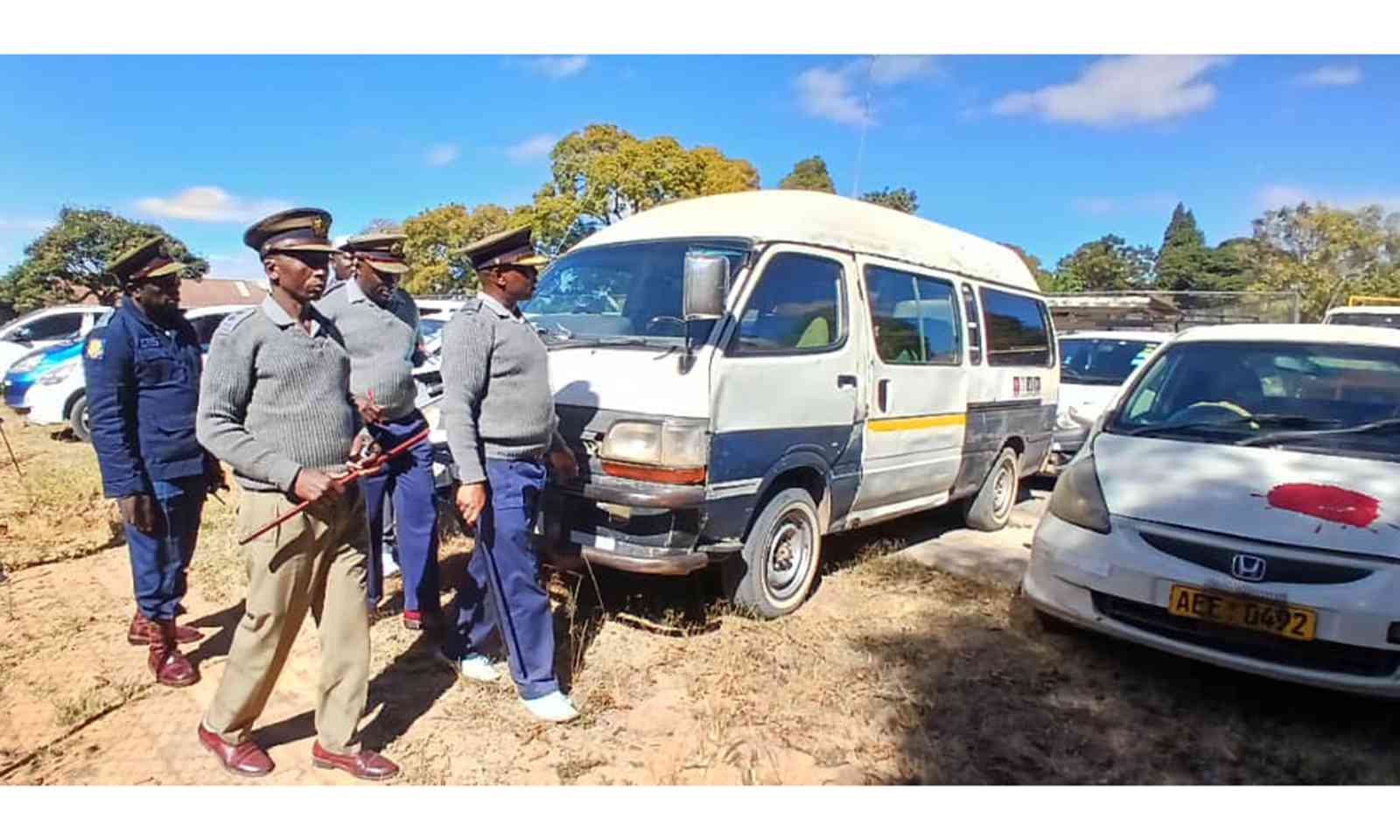 Police officers strip impounded vehicles