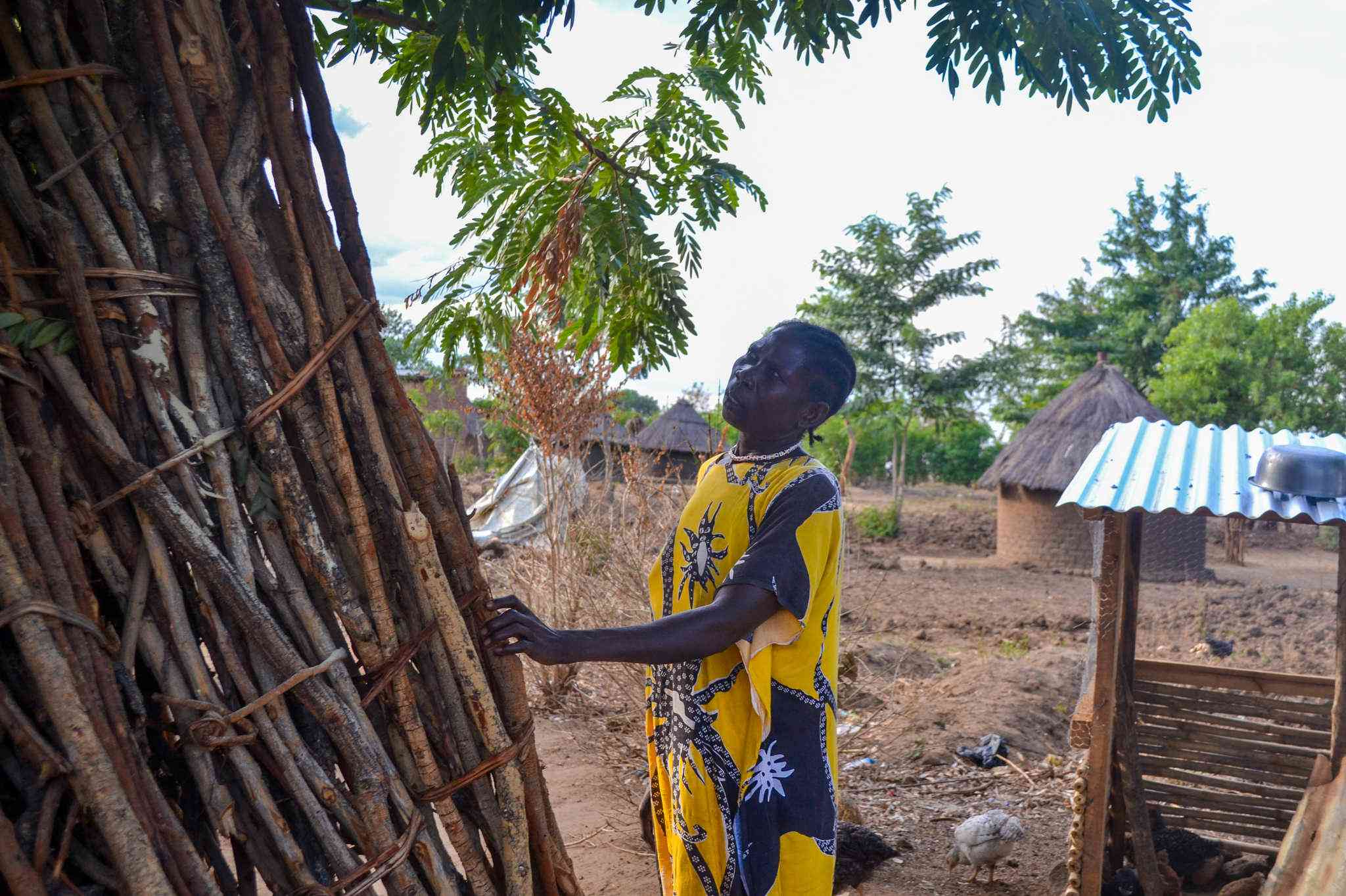 Rose Foni, 40, stands in Pagirinya Refugee Settlement. She first fled South Sudan in 2016 with her children and grandchildren. Although she briefly returned home in 2024, renewed violence forced her back to the camp — now more crowded and underfunded than ever before.